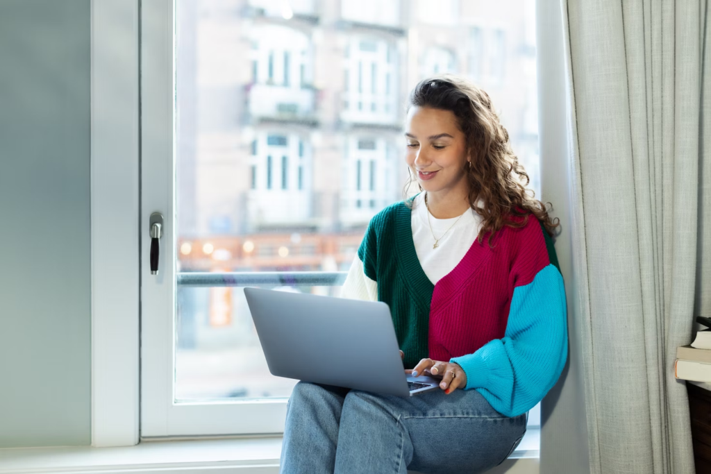 woman using a laptop - How to Merge Multiple Google Calendars into One