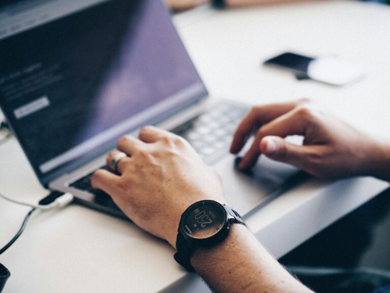 man typing on a laptop - Activtrak vs Teramind
