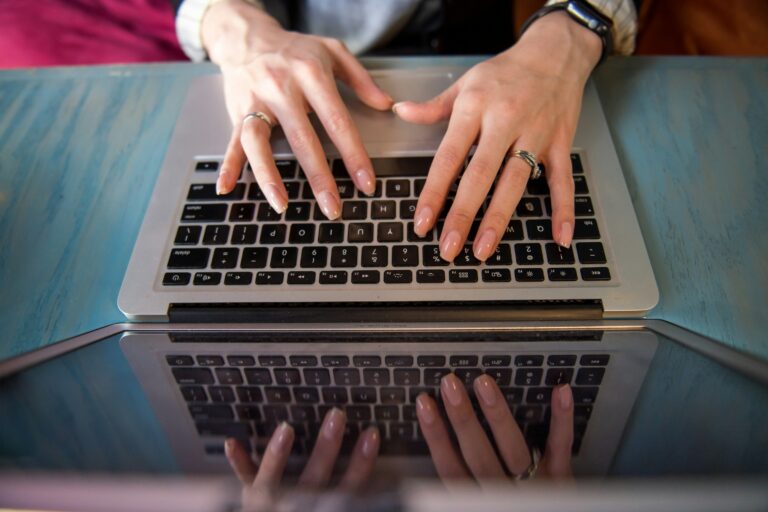 woman typing on a laptop - Time Audit App
