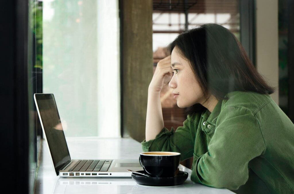 woman looking at a laptop - Project Management and Billing Software