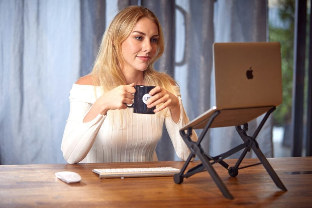 woman with a cup - FreshBooks Alternatives