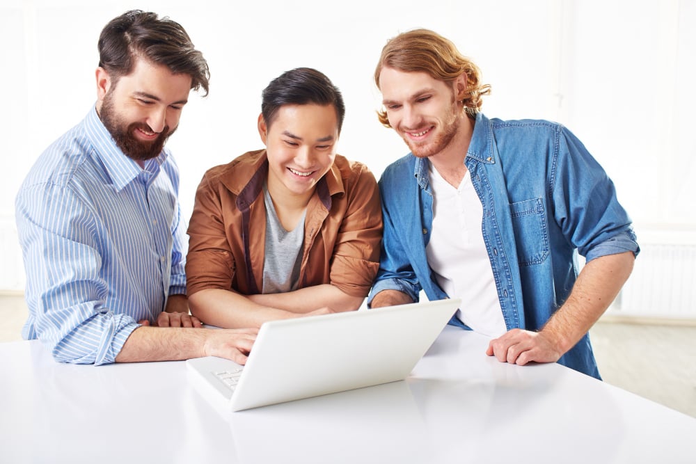 employees smiling - Monday vs. Asana