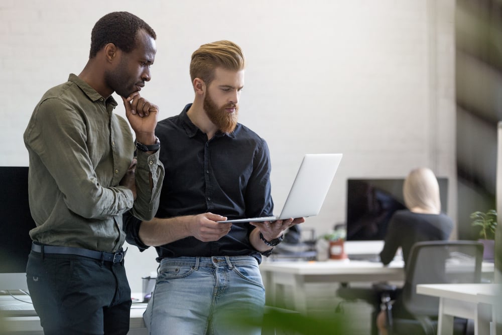 men using a laptop - Microsoft Project vs Trello