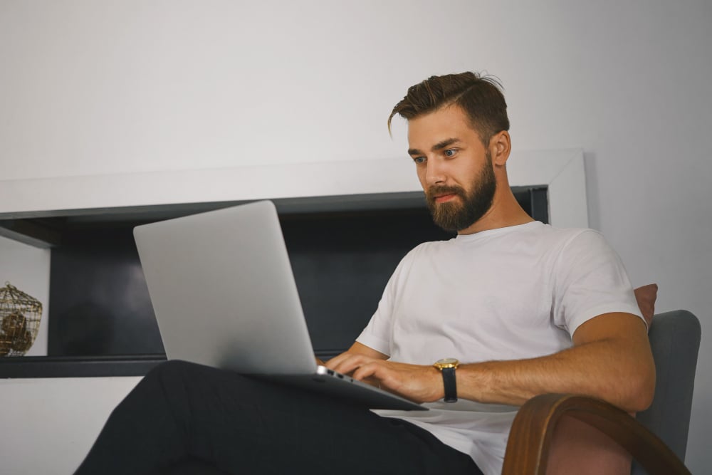 man sitting on a sofa - Monday.com vs Jira