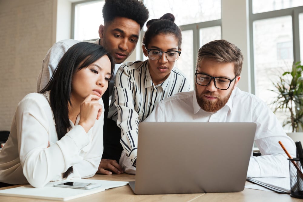 employees on a laptop - Monday vs. Asana