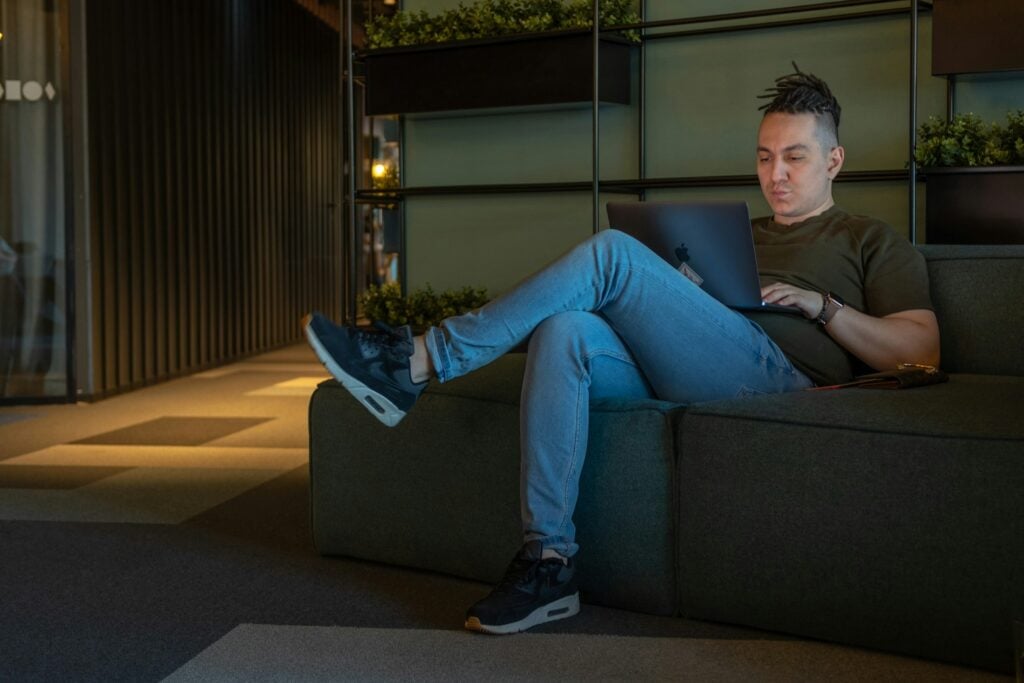 man sitting on a laptop - Microsoft Project vs Trello
