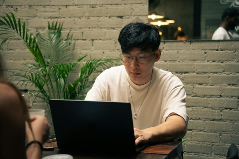 man doing work on a laptop - Monday.com vs Basecamp
