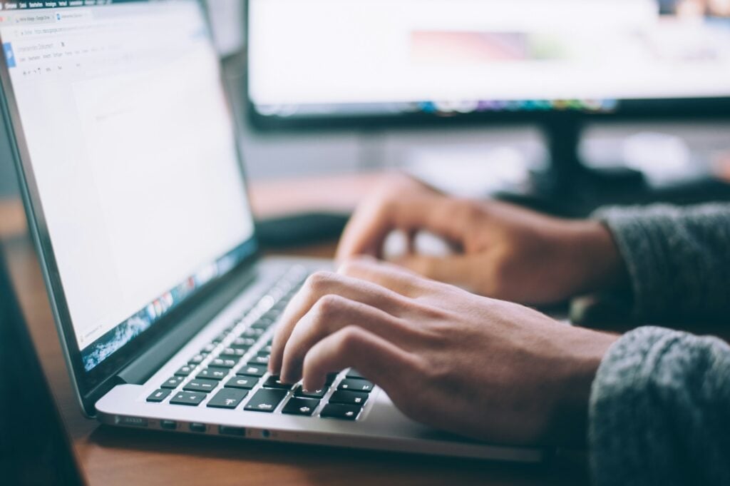 Person Using Laptop - Agency Resource Management Software