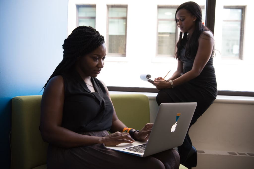woman looking at a laptop - How to Keep Track of Projects at Work
