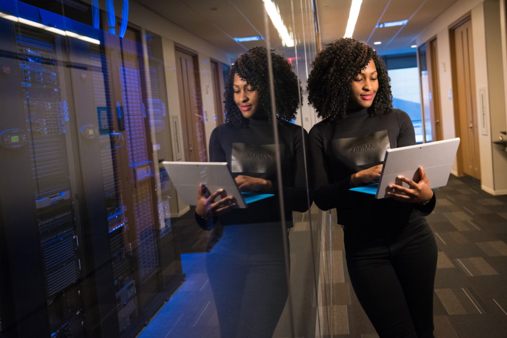 woman standing with a laptop - How to Keep Track of Projects at Work