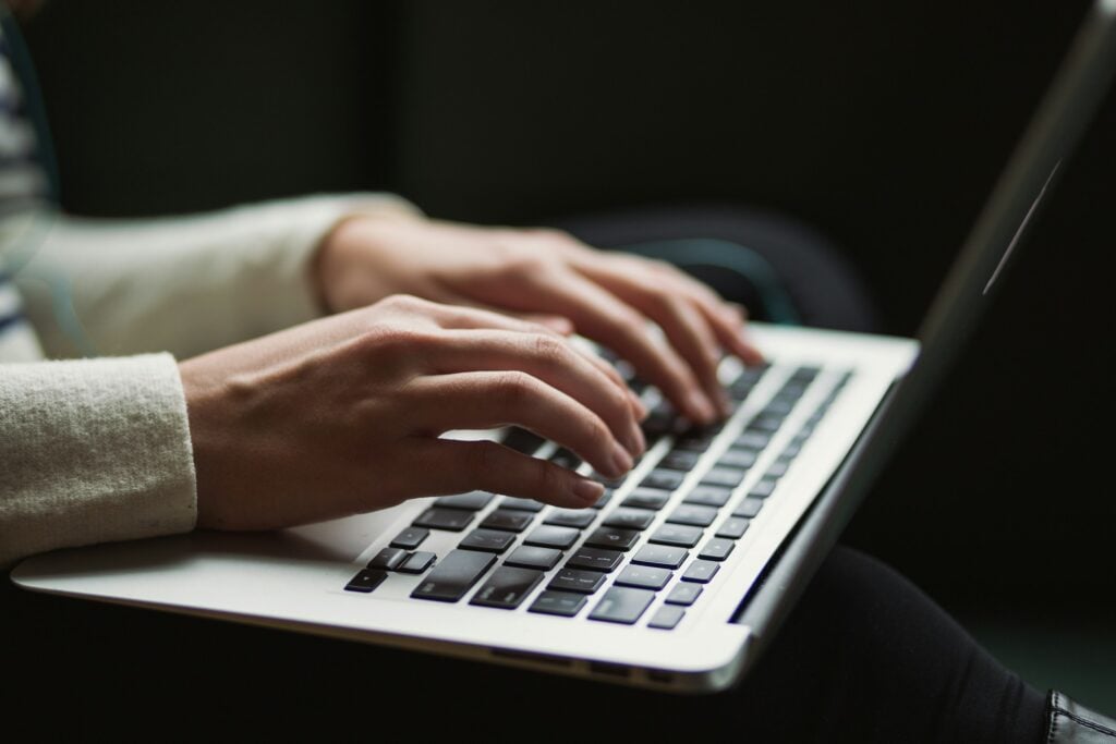 Person Working on Laptop - Project Delivery Management