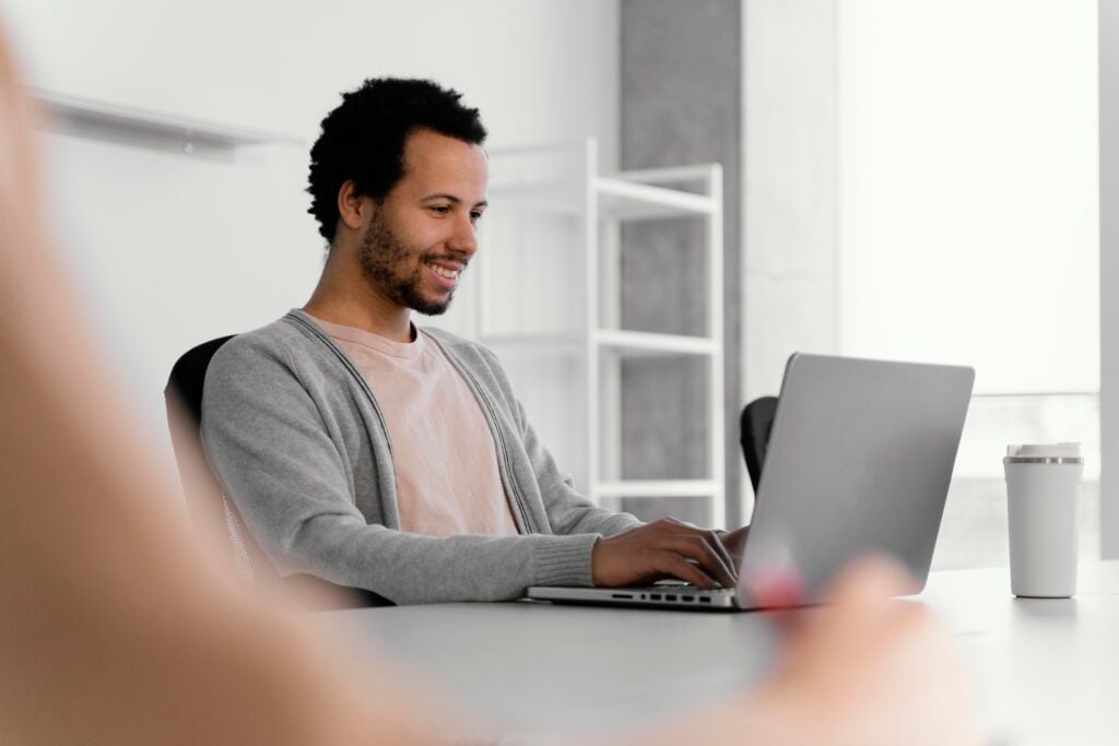 man using a laptop - Monday.com vs Jira