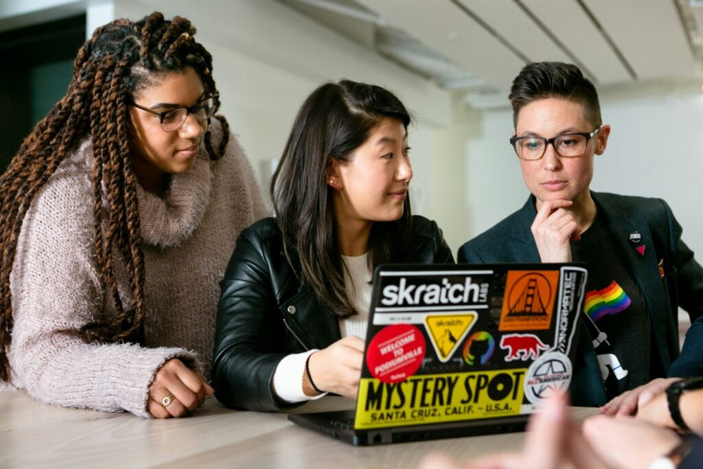 employees on a laptop - Best Agency Project Management Software