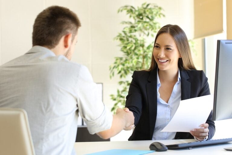 employees shaking hands - Leadership Interview Questions