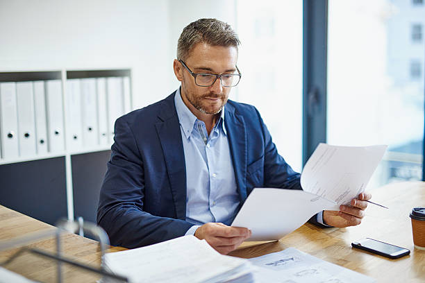 man reading documents - Leadership Interview Questions