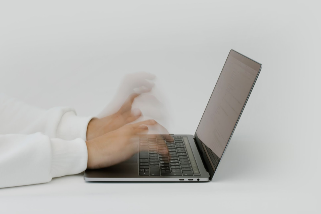 man typing on a laptop - How to Make Time Go Faster at Work 
